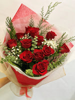 One dozen red roses with green and baby's breath.
