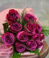 A dozen roses with magenta color